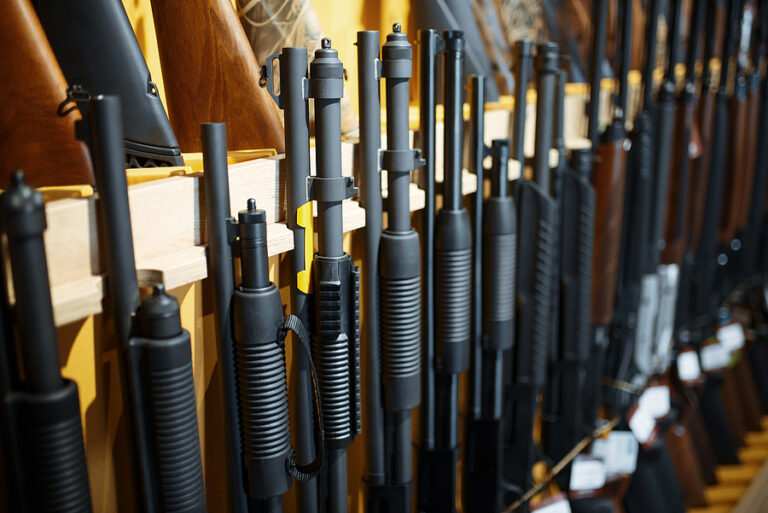Row of rifles in gun shop closeup, nobody